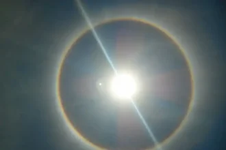 A photo of the sun with the rainbow ring around indicating heat