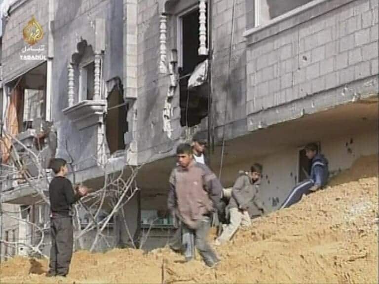 A boy walks through a building In Gaza that was bombed by the IDF