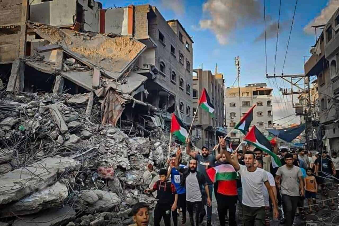 Palestinians walk through the destruction in northern gaza.