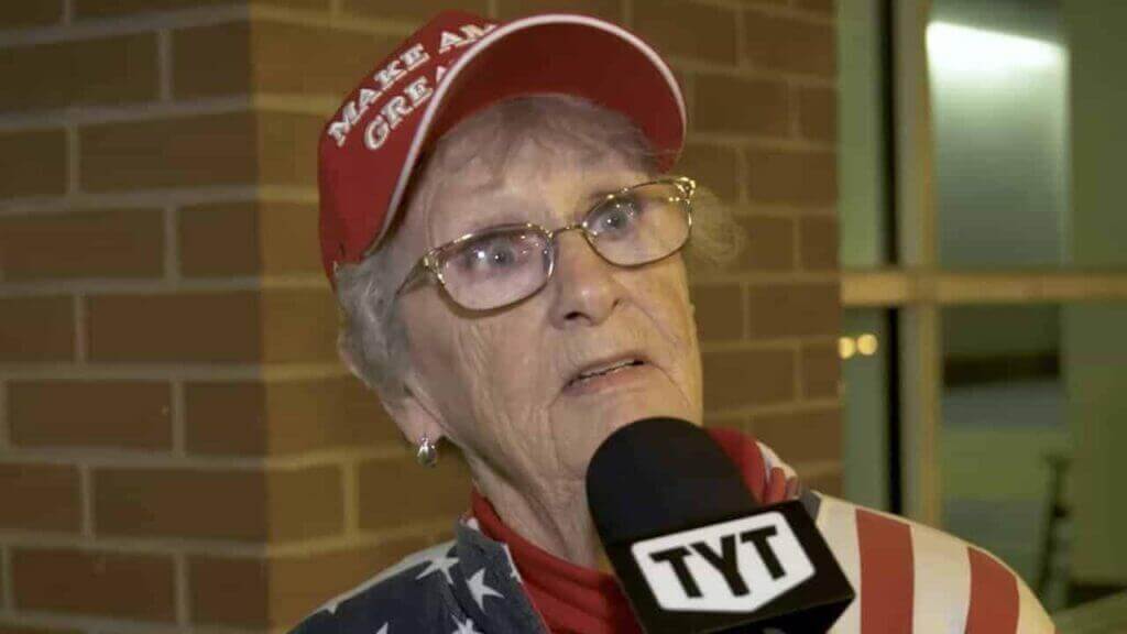 An elderly trump supporter with a shocked look on her face.