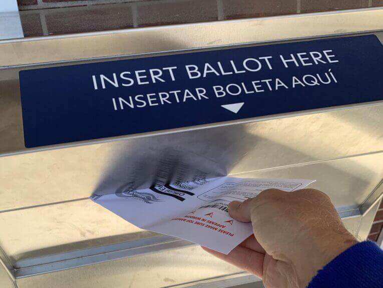 A voter returning a mail-in ballot something that was railed against in Trump’s primetime speech
