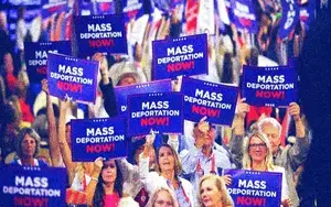 Crowd at the RNC holding ‘mass deportation now’ signs