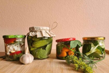 Jars of fermented foods on a wooden counter or table