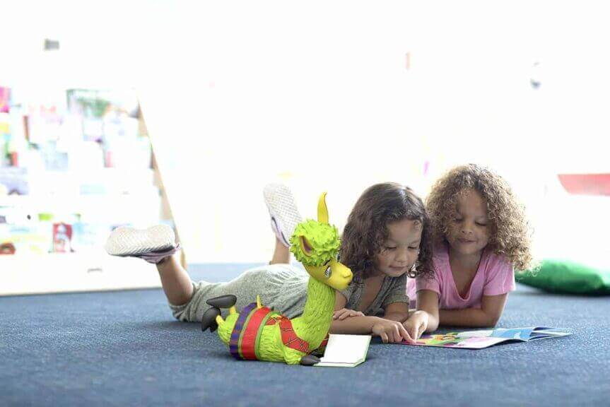 Environmental activities for kids children lying on the floor reading a book together