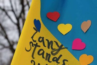 War in ukraine: ukranian flag with hearts and written in black marker: zany stands with you. ”