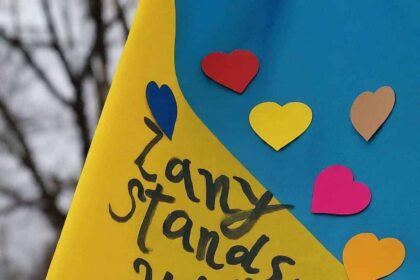 War in ukraine: ukranian flag with hearts and written in black marker: zany stands with you. ”