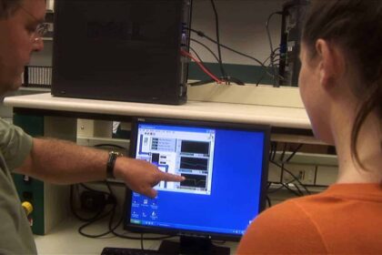 Computer techs looking at a monitor