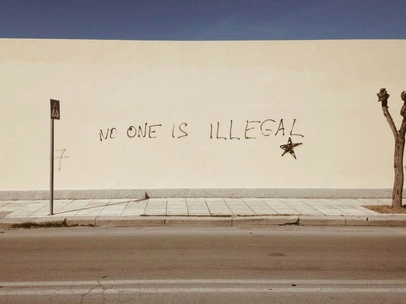 Immigration policy in the united states: no one is illegal painted on a wall
