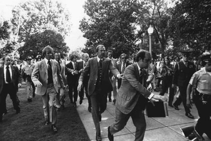 Following the september 5, 1975 10:04 am[1] attempt on u. S. President gerald ford's life by cultist charles manson family member lynette "squeaky" fromme, secret service agents rush president ford towards the california state capitol in sacramento.