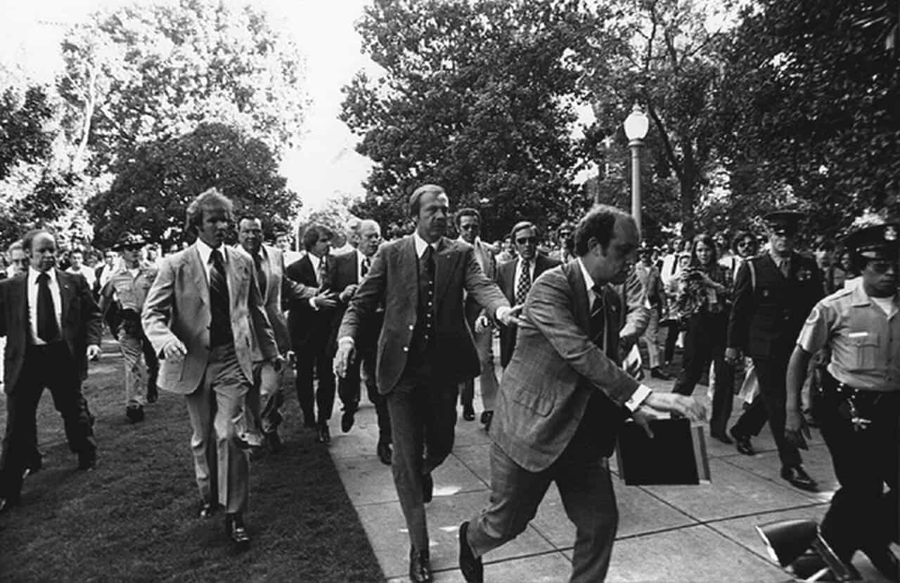 Following the september 5, 1975 10:04 am[1] attempt on u. S. President gerald ford's life by cultist charles manson family member lynette "squeaky" fromme, secret service agents rush president ford towards the california state capitol in sacramento.