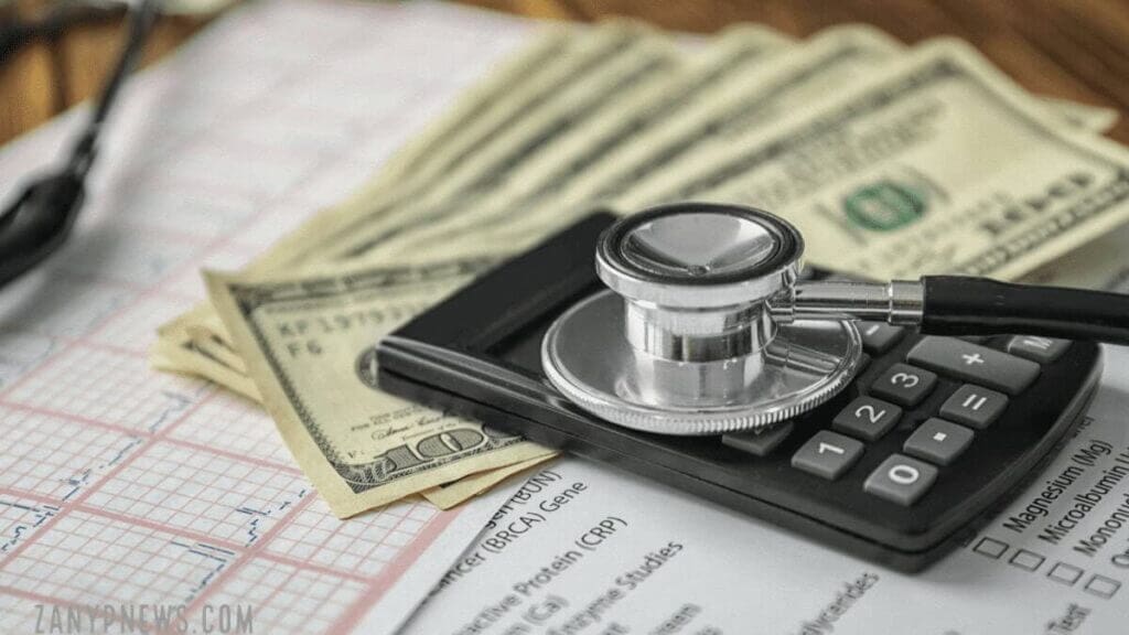 Medical debt: EKG, calculator and a stethoscope on cash