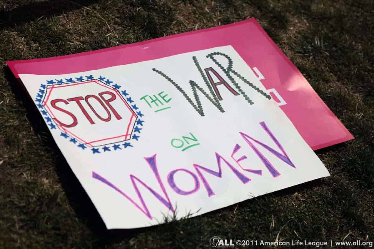 Protest sign: “stop the wat on women”