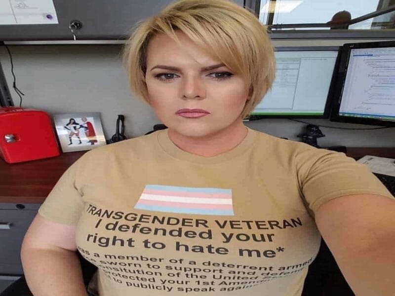 Transgender veteran wearing a shirt that says i fought for your right to hate me