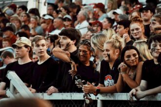 Teens/high school students at a football game.