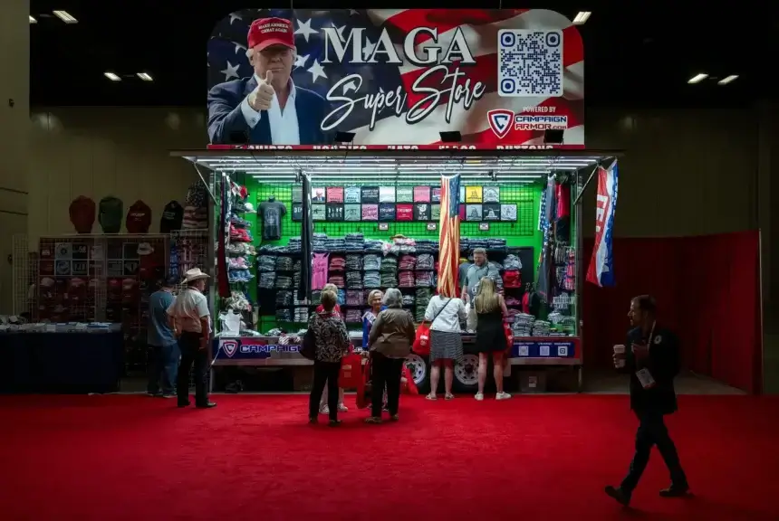 Conventioneers browse a Donald Trump-themed clothing stand at the Texas GOP Convention on May 23, 2024.