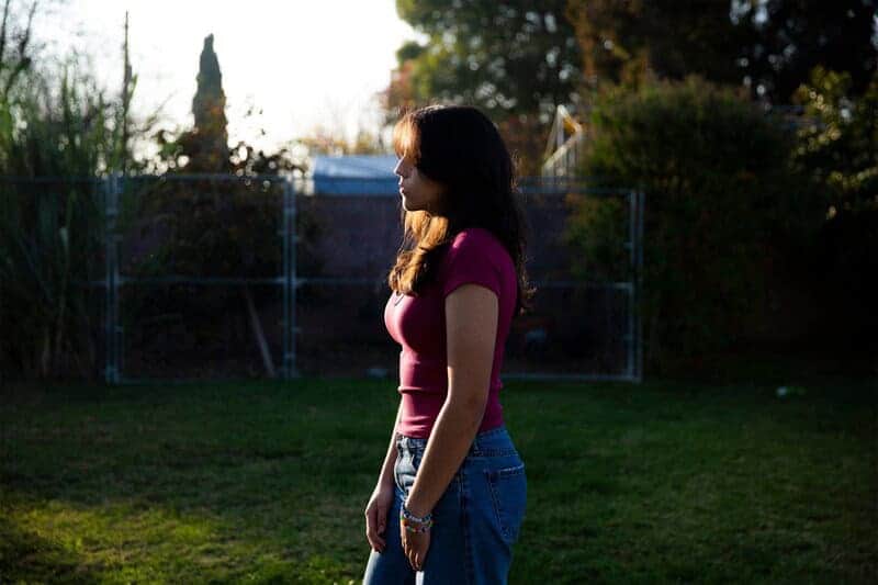 Climate change is affecting teens mental health A teen girl stands outside
