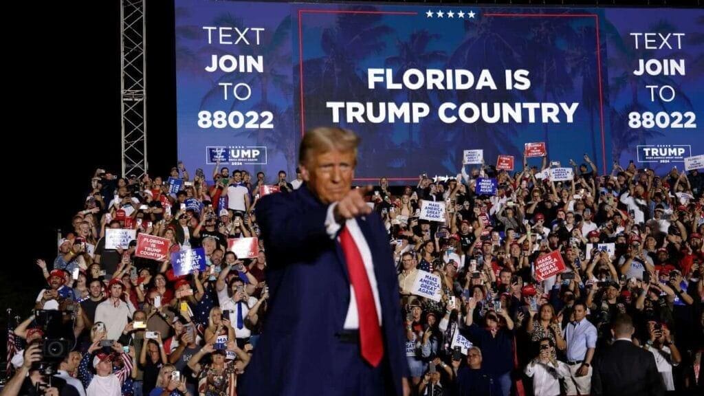 Elon Musk is taking over while Trump sits idly by.Donald Trump pointing at supporters at a rally