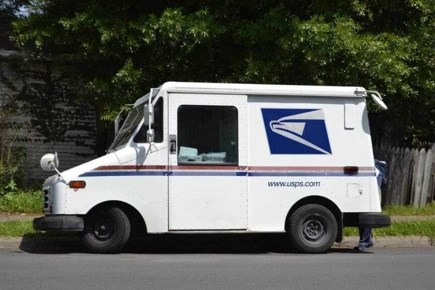 USPS truck parked on a street mail-in voting order