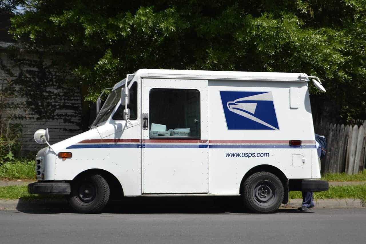 USPS truck parked on a street mail-in voting order