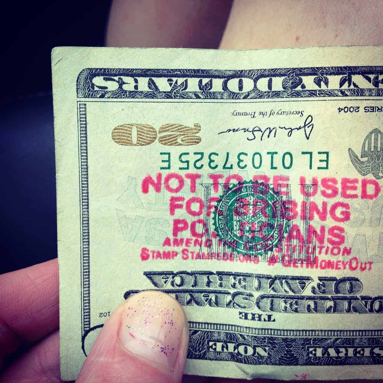 $20 bill with red text stating it can’t be used to bribe politicians.