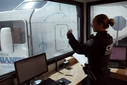 A u. S. Customs and border protection officer checks the identification of truck driver as he passes through the u. S. Checkpoint of the cargo pre-inspection at the otay mesa, calif. , port of entry, june 22, 2016. On any given day, several hundred trucks line up on the mexican side of the border to deliver imports ultimately awaiting the process of screening by customs officers.