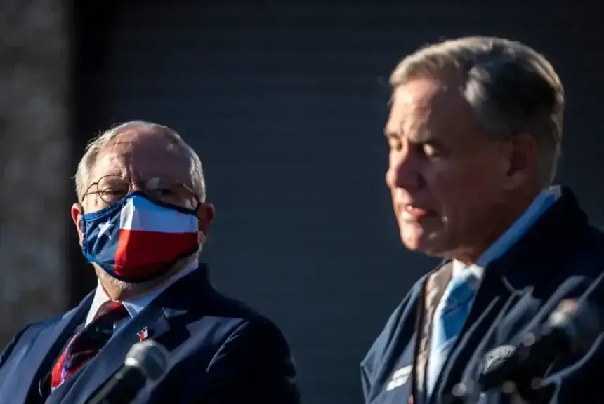 Dr. John hellerstedt, left, looks on at a news conference in austin on dec. 17, 2020 as gov. Greg abbott speaks about the covid-19 pfizer vaccines that had been sent to hospitals across texas.