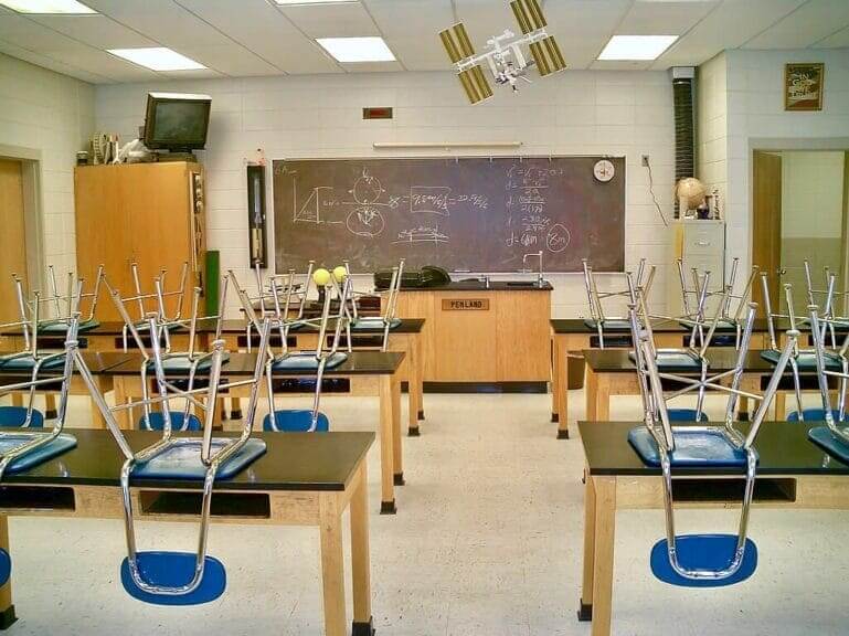 high school classroom Keep them stupid a high school classroomsith chairs up on desks to clean the floor