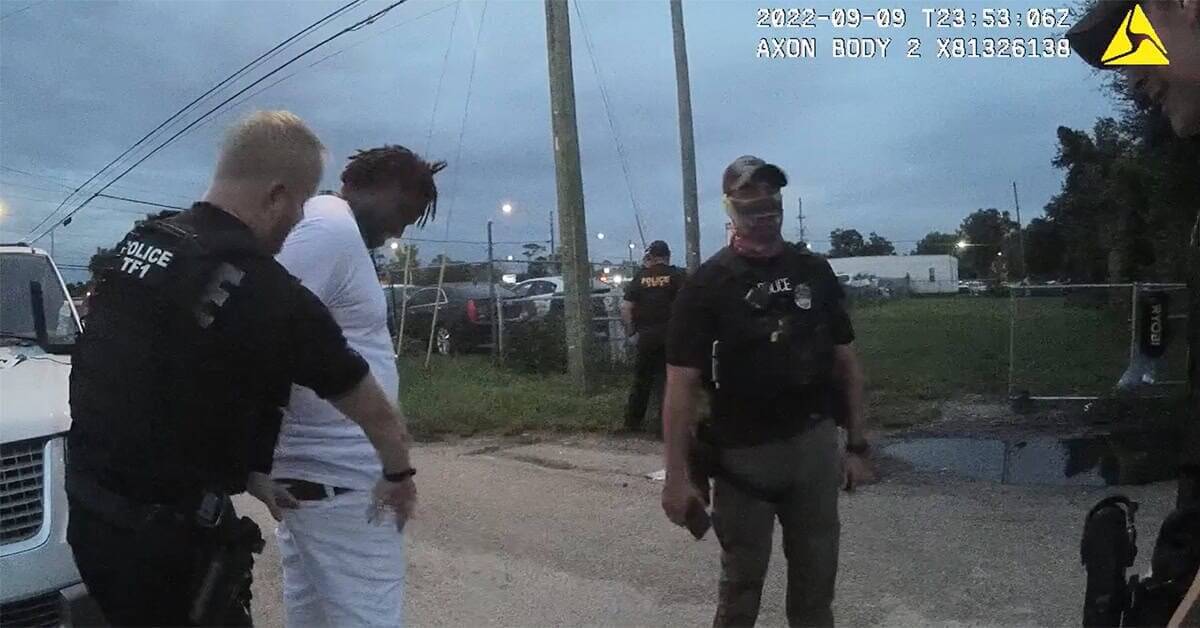A screengrab from body-worn camera footage shows jacksonville sheriff’s office police preparing to strip search ronnie reed.