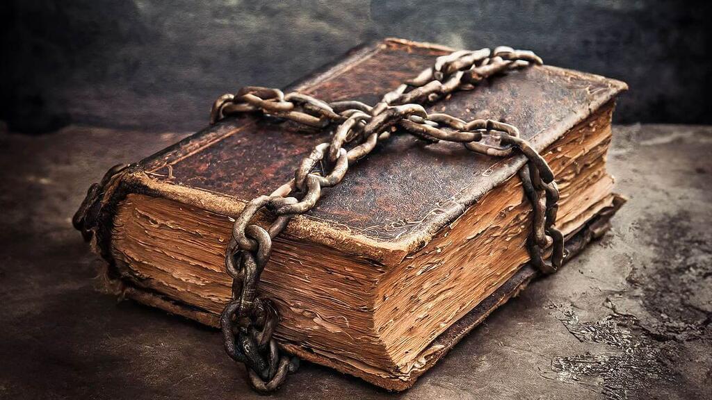 A vintage book wrapped in chains to signify banned books