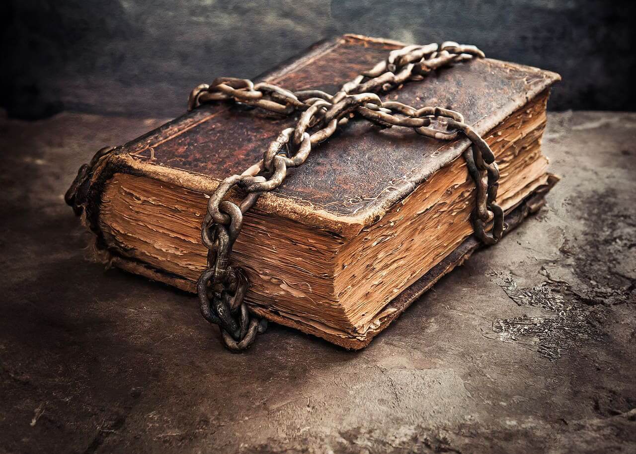A vintage book wrapped in chains to signify banned books