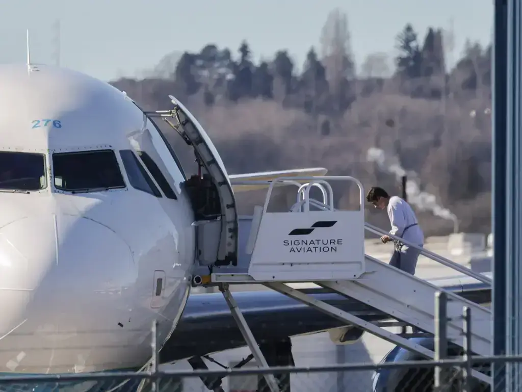 Ice air detainee boarding a plane in shackles