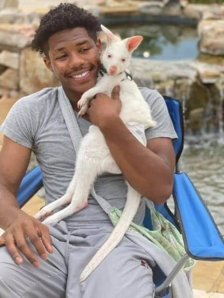 Black landowners like this black farmer holding a baby animal