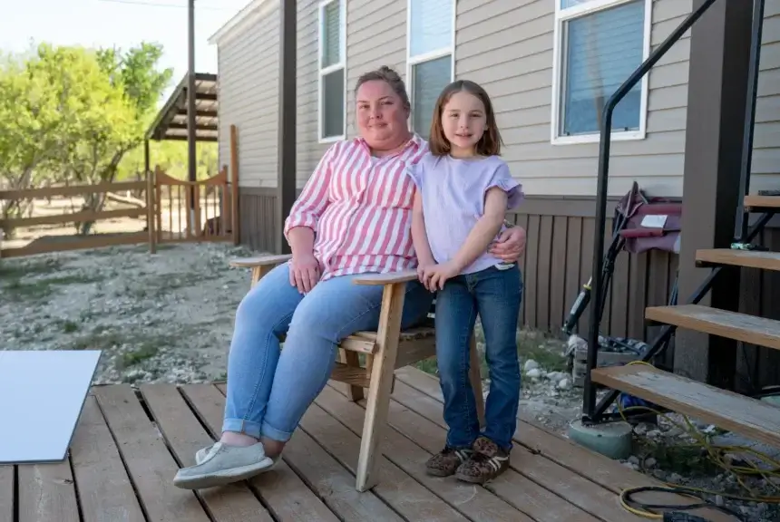 People prefer basic resources over border security. Mother and daughter sitting on their front porch