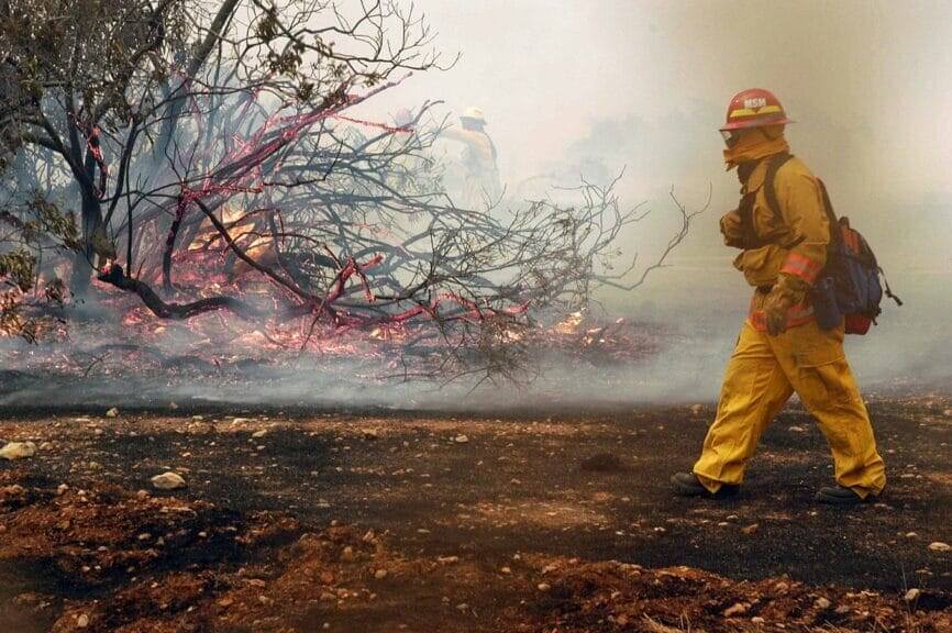 Fire fighters from the Miramar Fire Dept. fight a small brush fire on the east side of a Hanger aboard Marine Corps Air Station (MCAS) Miramar, Calif.