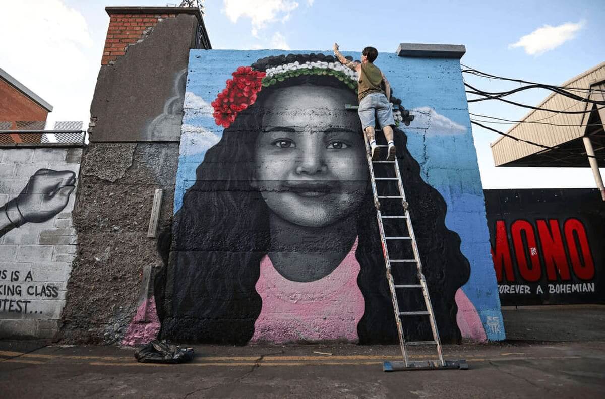 Mural of hind rajab on the exterior of a building. The paramedic massacre was happening back when she was killed.
