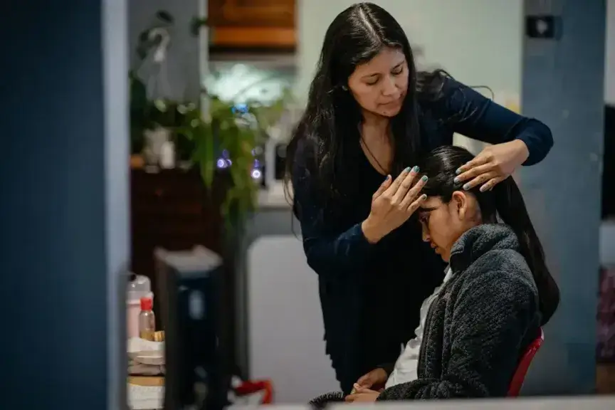 Yessenia ruano fixing her daughter’s hair