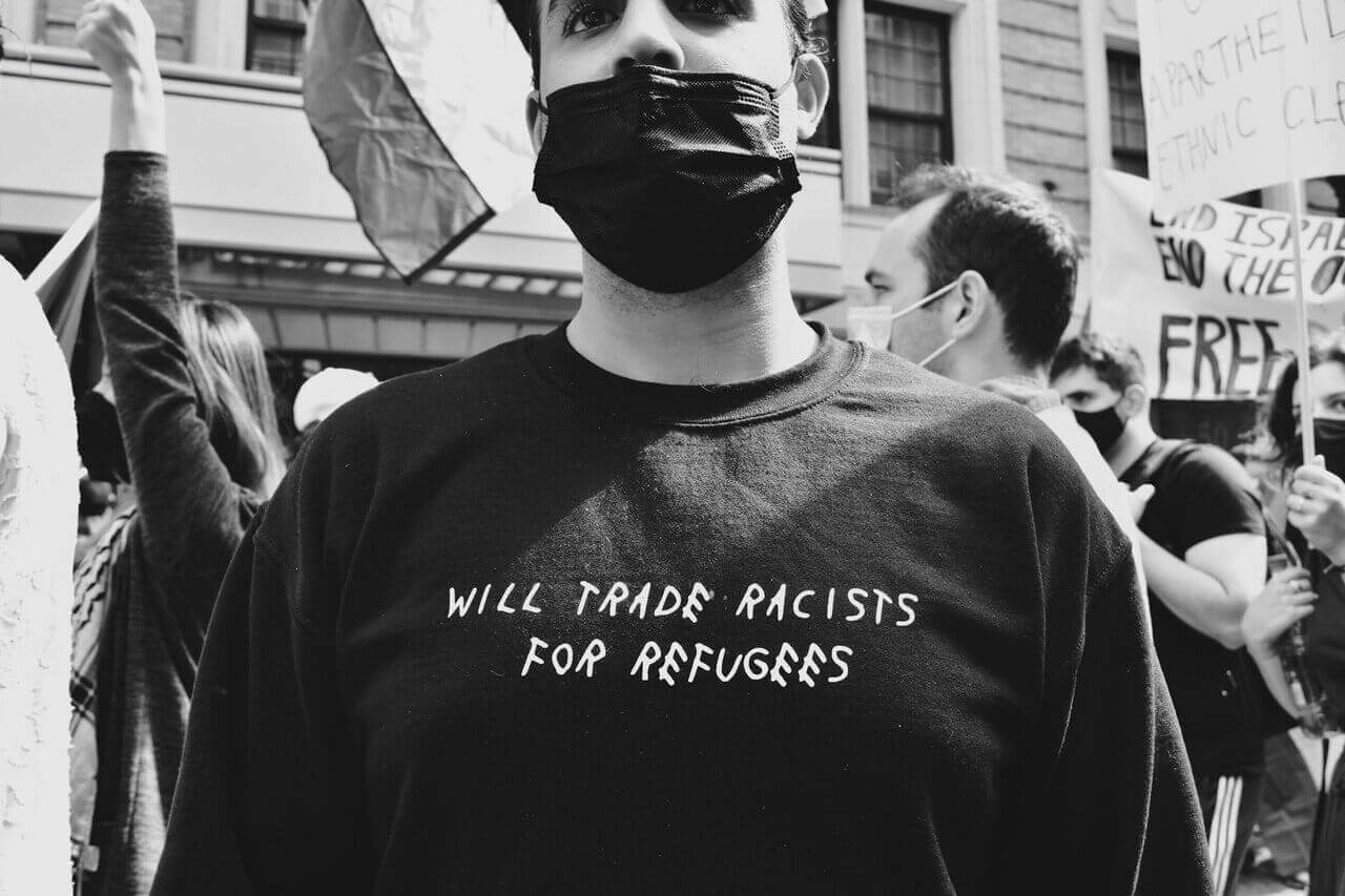 Protected status holders are supported by advocates like this protester.