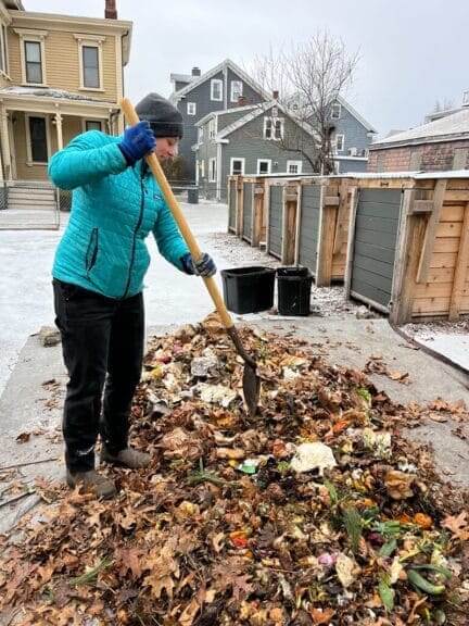 Woman in a composting heap to recycle food waste