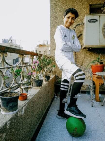 Gazan refugee children like this boy with a foot on his soccer ball
