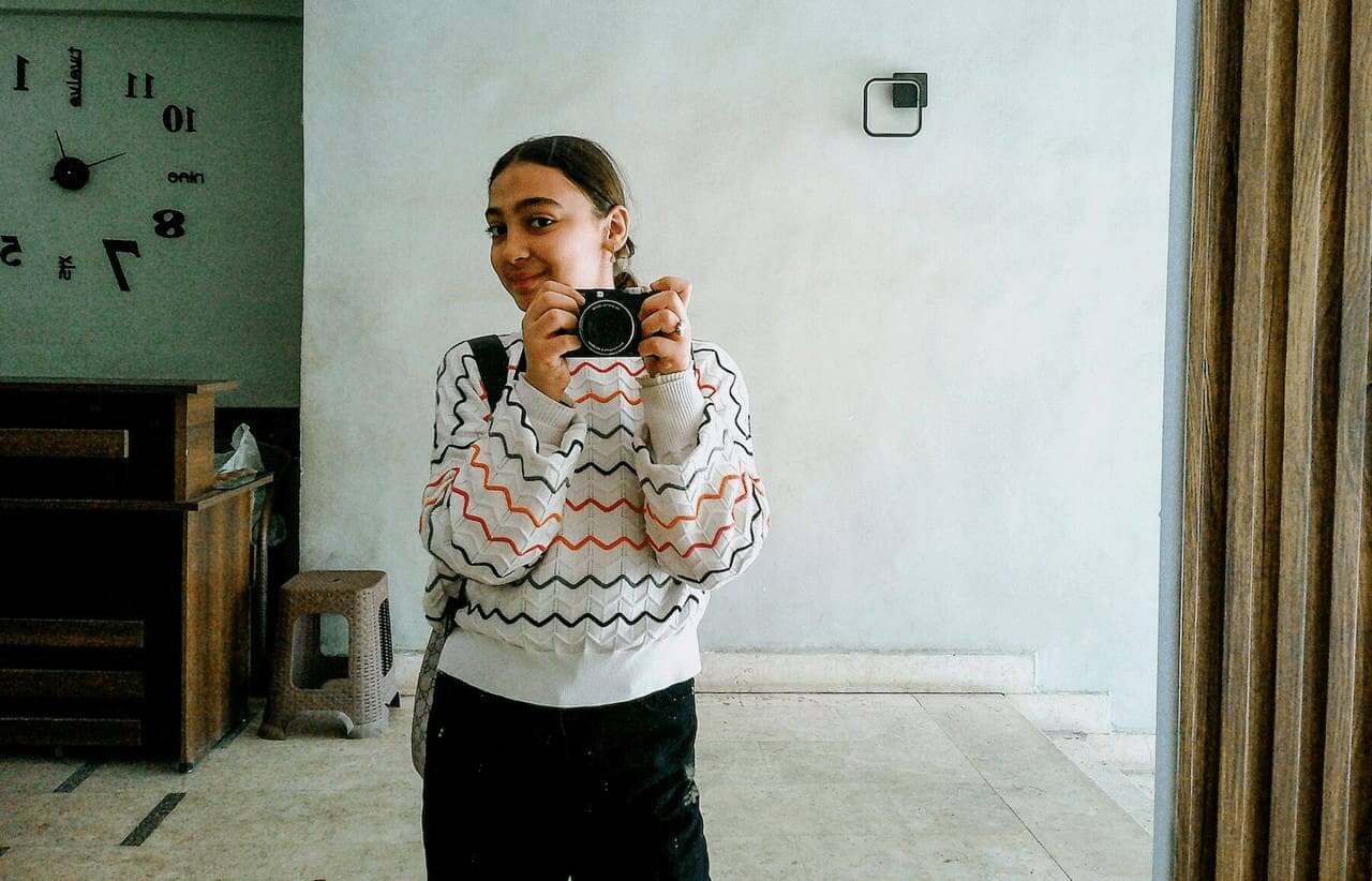 Young palestinian girl holding a camera