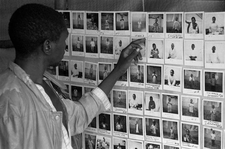 Rwandan genocide victims photos on a wall.