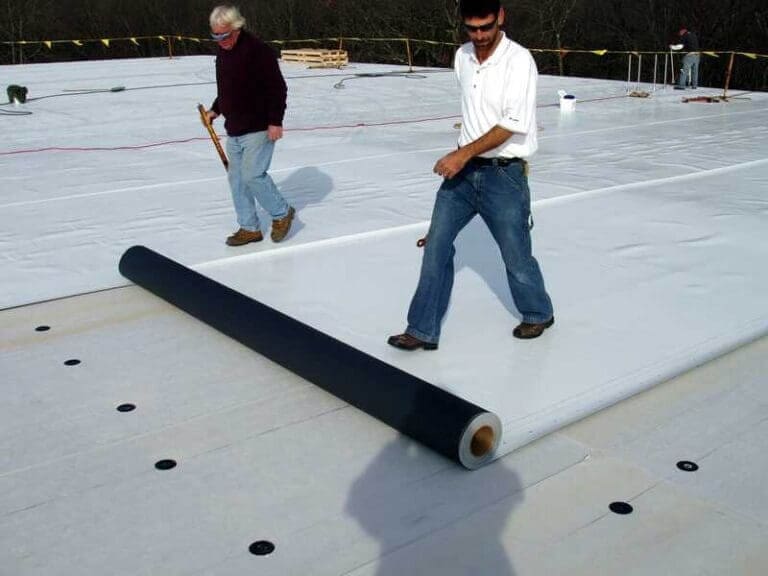 dark roof lobby4 Workers lay down white pvc roofing material
