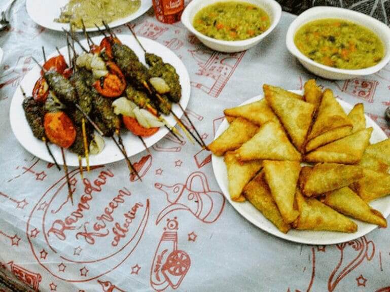 Gazan refugee children prepare plates of food for dinner