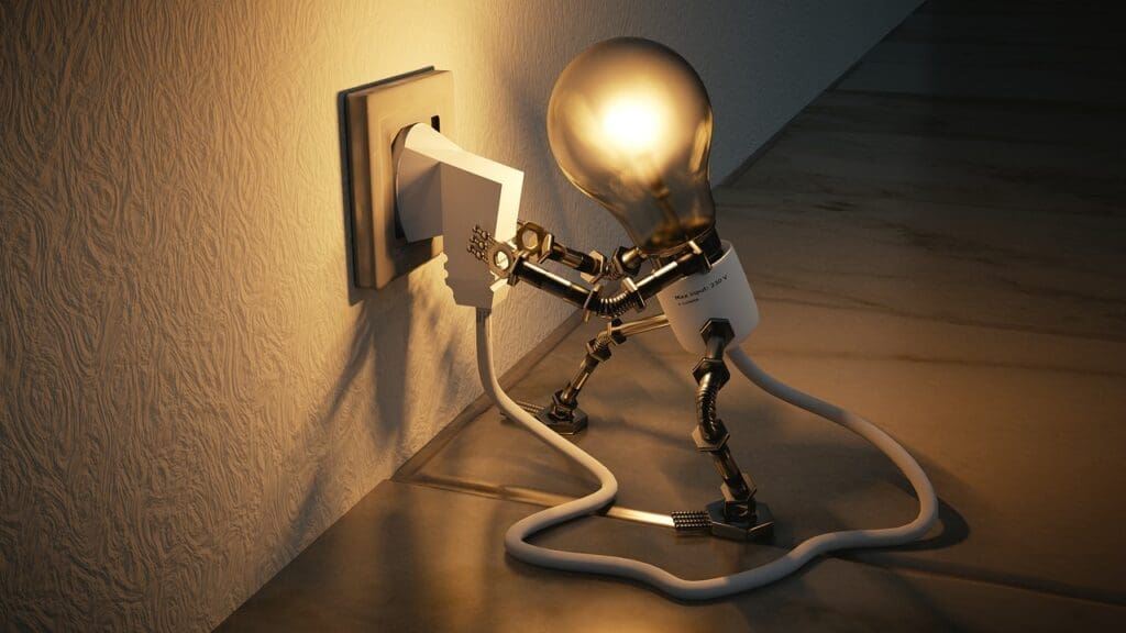 Lightbulb plugging itself into a wall socket.