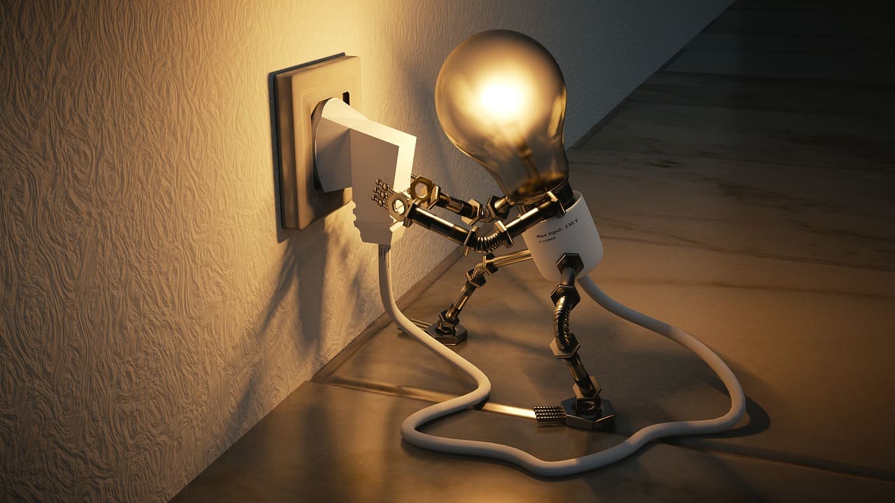 Lightbulb plugging itself into a wall socket.