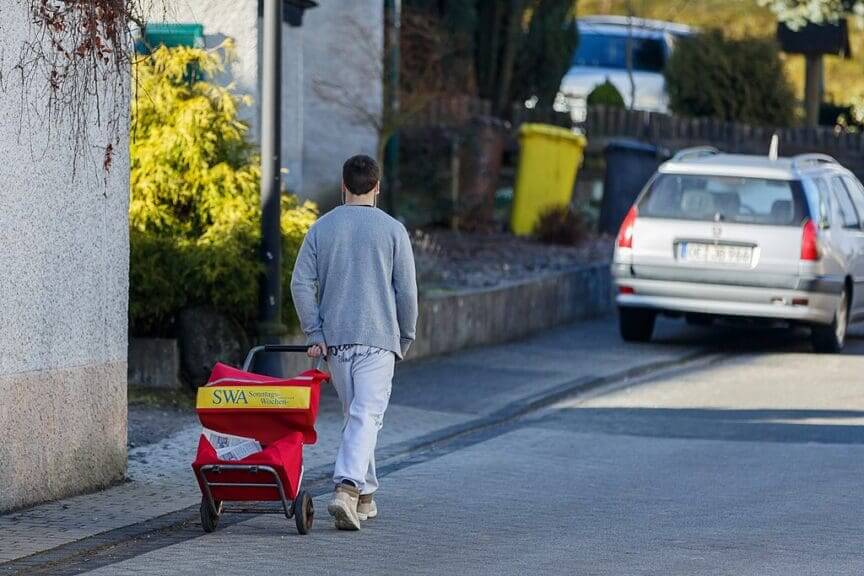 Boy delivering the newspaper in germany