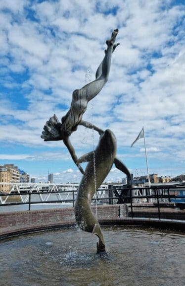 A statue of a woman with a dolphin