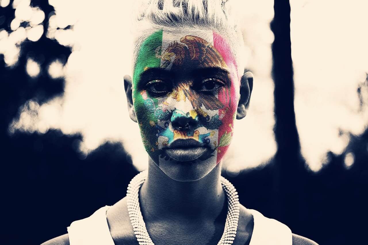 Woman with mexican flag painted on her face