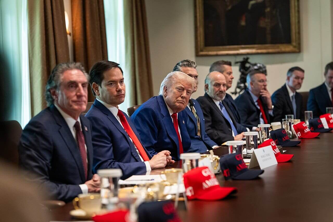 Trump and crew in a cabinet meeting with doug collins sitting at the table in the next to last seat.