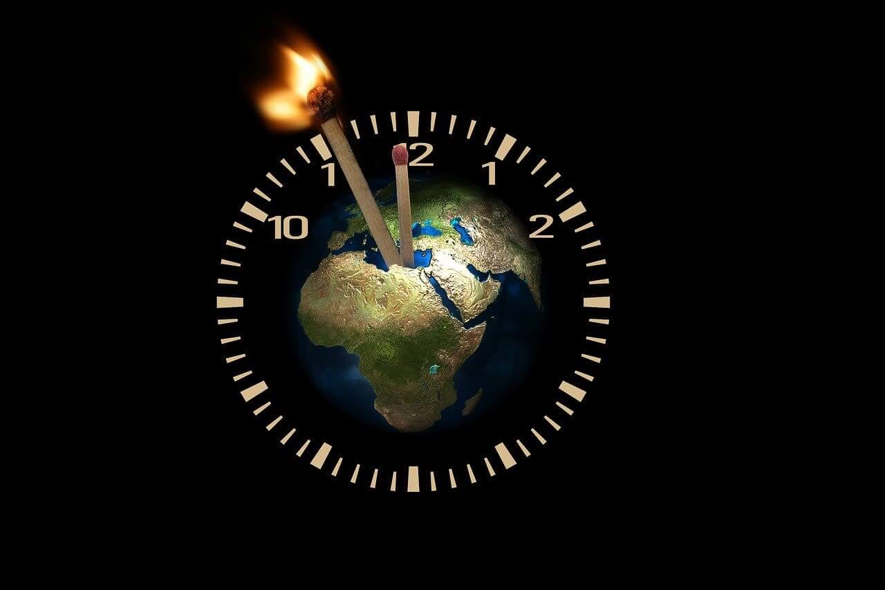 Graphic of the planet in the center of a timer with matches as the hands of the clock. The minute hand match is lit.